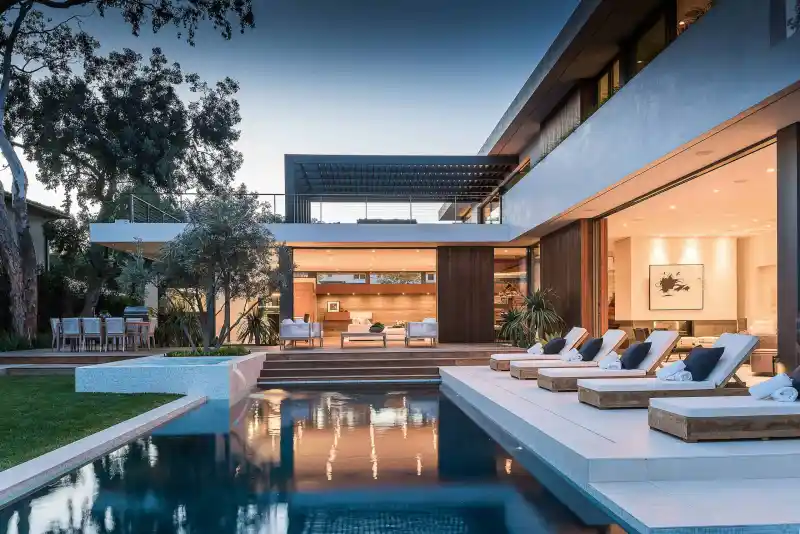 Custom in-ground swimming pool with landscaped backyard